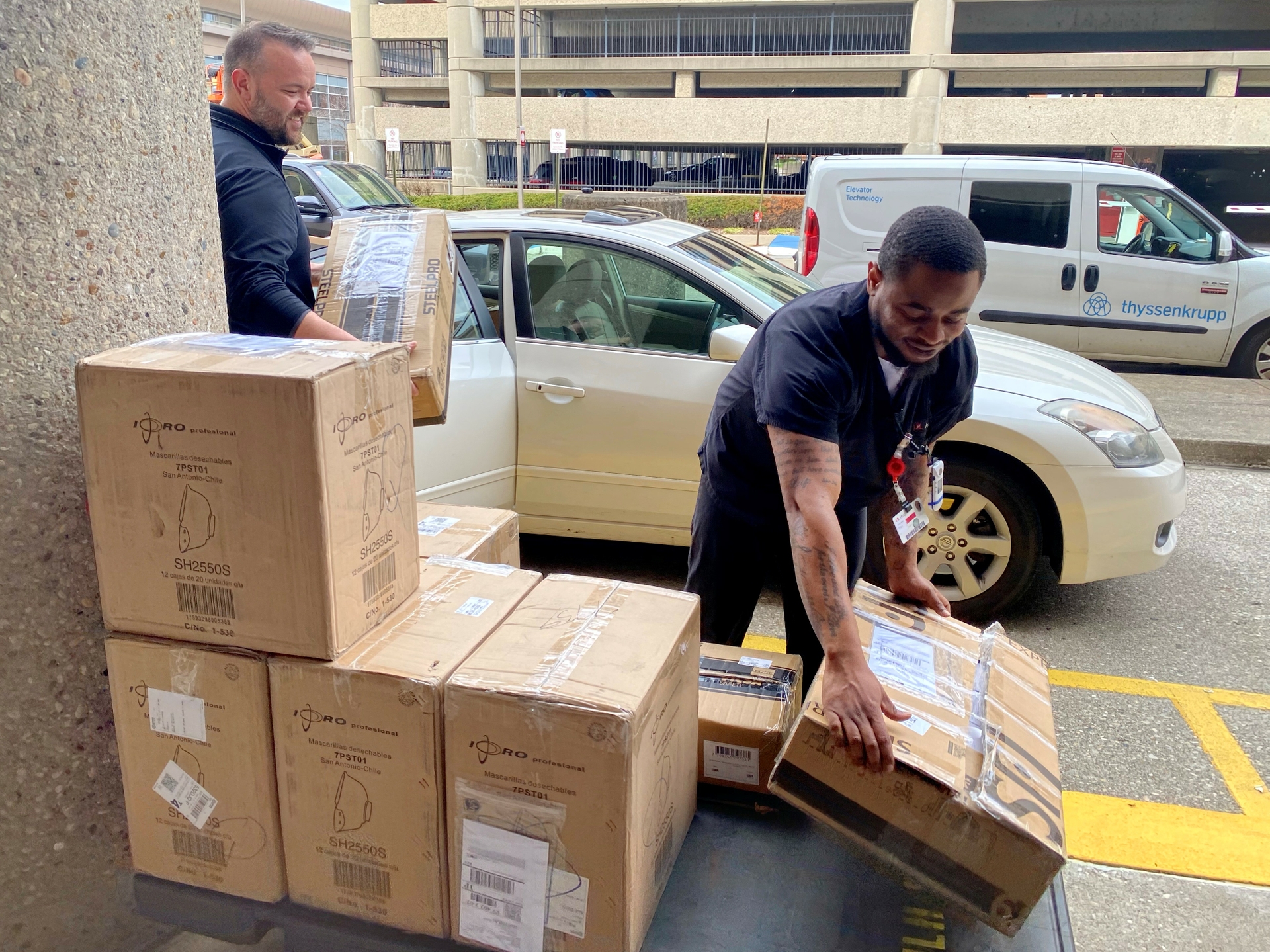 University of Louisville Health team accepts a donation of 2500 N95 masks from GE Appliances