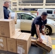 University of Louisville Health team accepts a donation of 2500 N95 masks from GE Appliances
