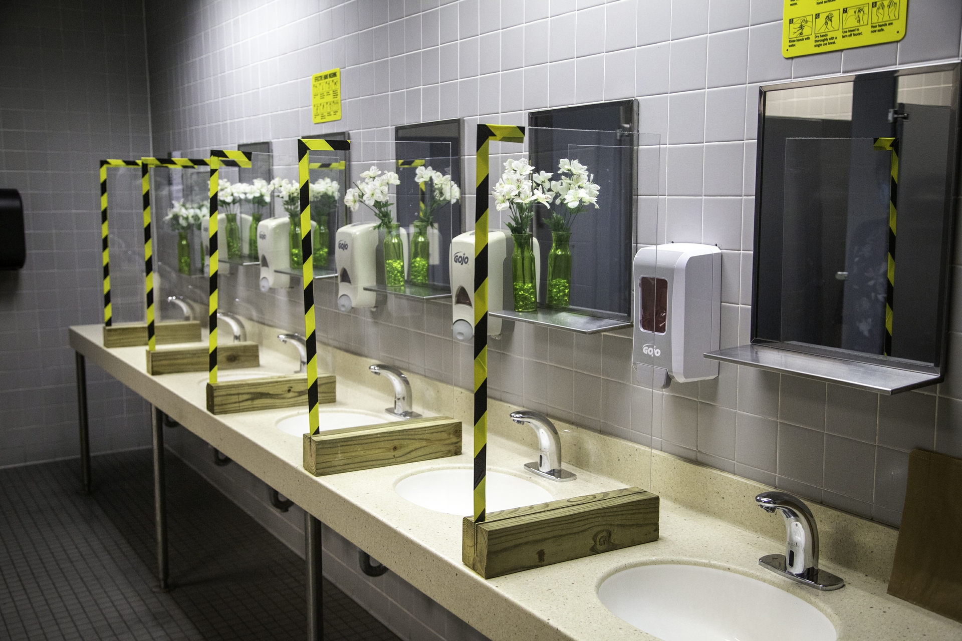 Solid Lexan barriers separate the sinks in the women’s restrooms.