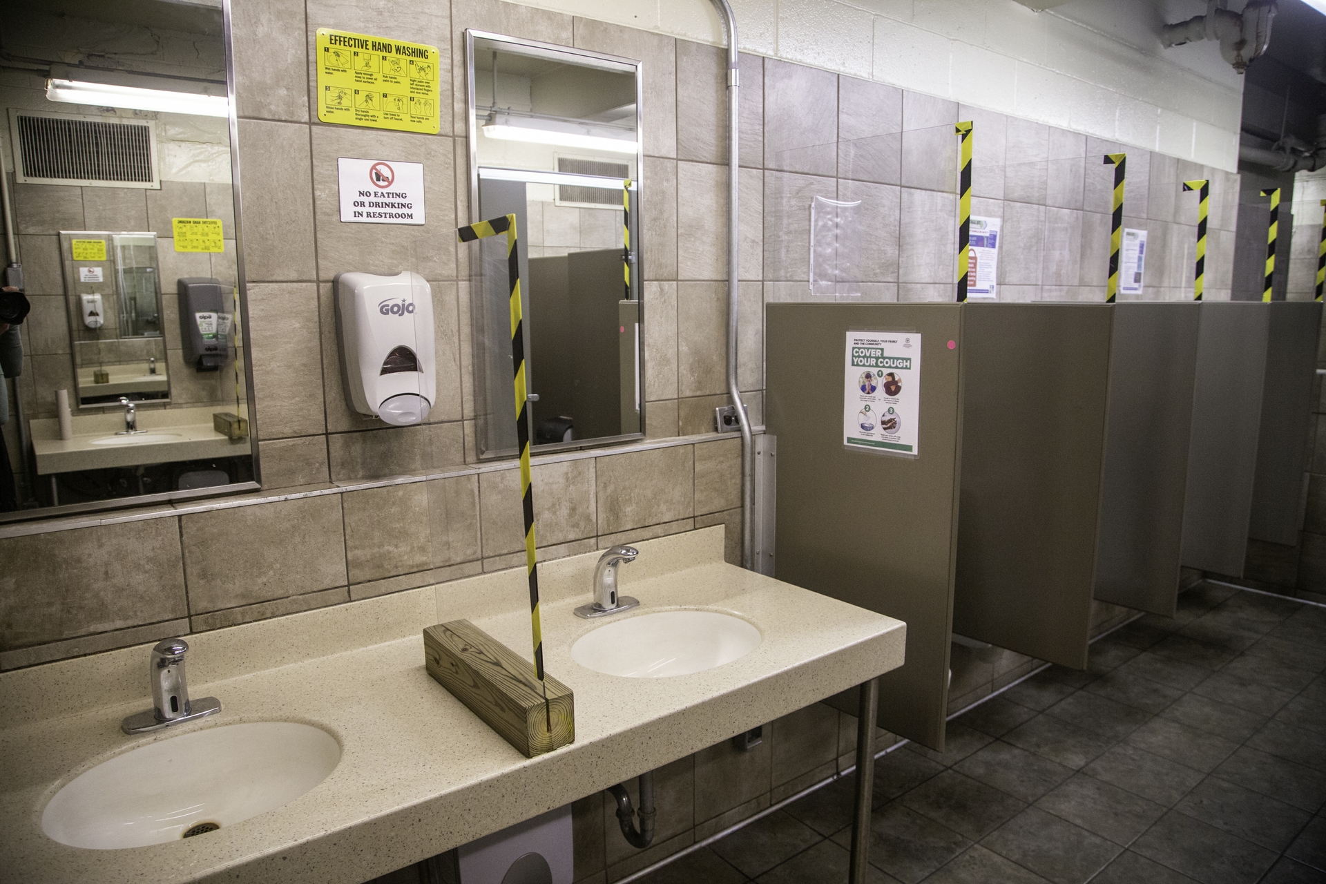 Solid Lexan barriers separate the sinks and urinals in the men’s restrooms.