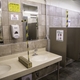 Solid Lexan barriers separate the sinks and urinals in the men’s restrooms.