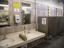 Solid Lexan barriers separate the sinks and urinals in the men’s restrooms.
