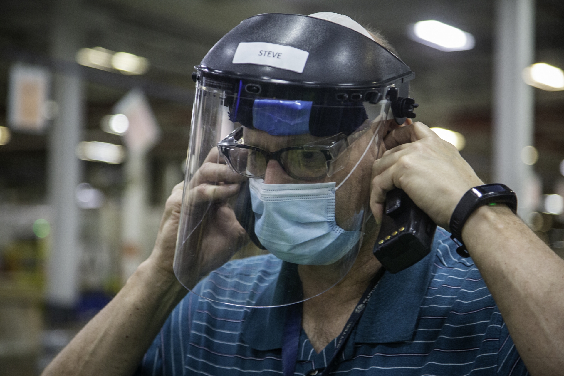 A Maintenance Business Leader wears his required mask and face shield.