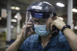 A Maintenance Business Leader wears his required mask and face shield.
