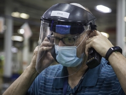 A Maintenance Business Leader wears his required mask and face shield.