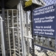 Instructional signage is posted at entrances on touchless turnstile entry.