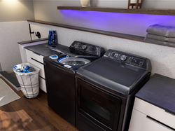 The GE Profile 900 Series Top Load Washer has SmartDispense Technology automatically adjusts the amount of detergent dispensed and Microban antimicrobial technology.