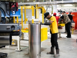 Operator Davonte Torres inspects the welding on a new water heater tank. The vertically integrated plant produces units starting from coils of steel into high-quality water heaters.