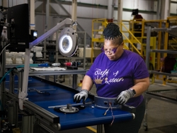 Operator Kim Fleming builds a burner assembly for the new water heaters being made by GE Appliances in Camden South Carolina.