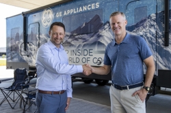 CEO of Midwest Sales and Services Inc. Heath Wechter shakes hands with CCO of GE Appliances Rick Hasselbeck as the two companies make the announcement.