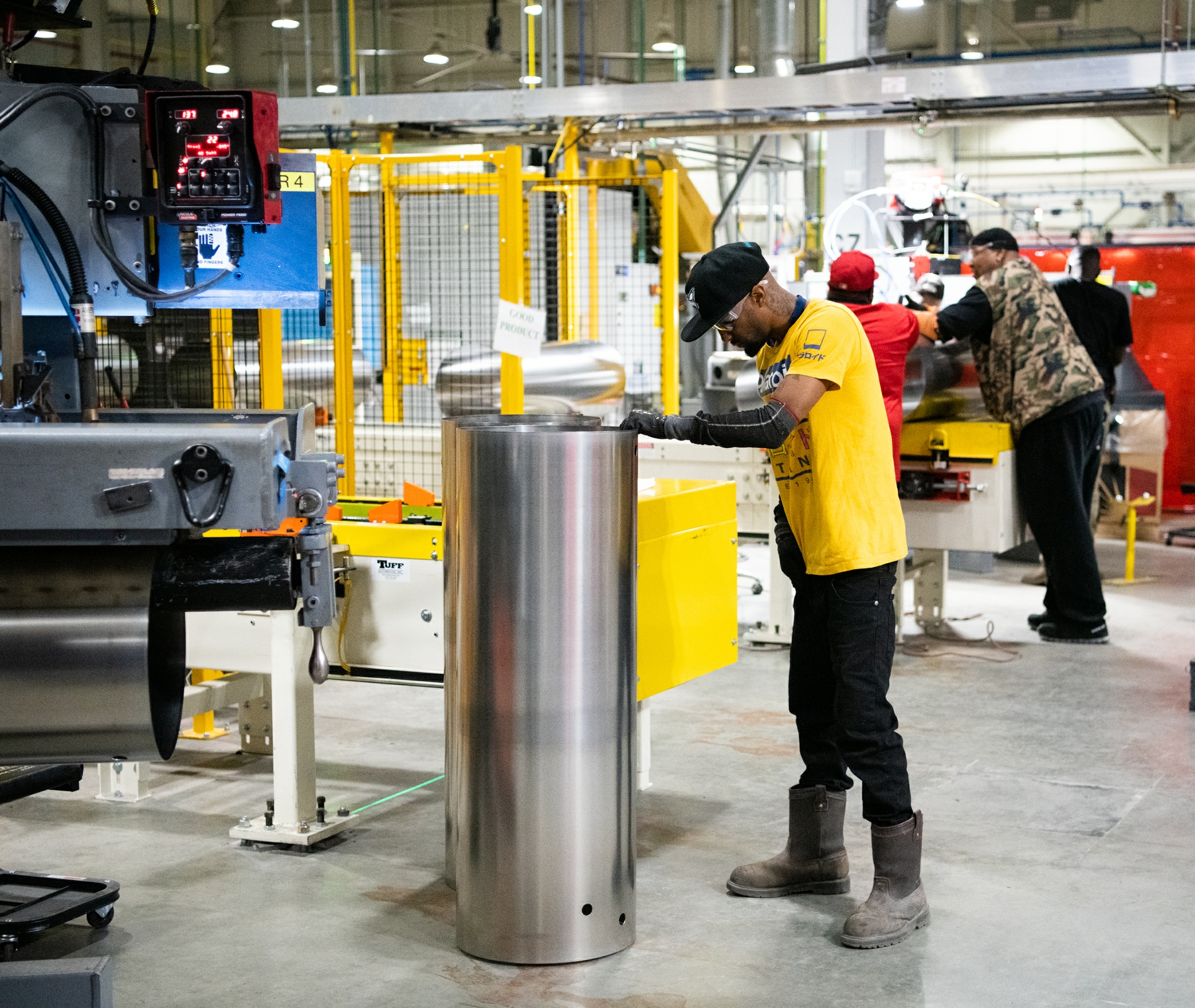 Operator Davonte Torres inspects the welding on a new water heater tank. The vertically integrated plant produces units starting from coils of steel into high-quality water heaters.