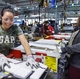 Operators Norma Morin, left, and Kossiwa Eggenam complete door assembly on the new assembly line inside the dishwasher plant at GE Appliances’ headquarters in Louisville, Kentucky.