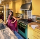 CAFÉ partner and interior designer Isabel Ladd at home with her CAFÉ 36” Duel Fuel Commercial-Style Range from the Emerald Green Capsule Collection