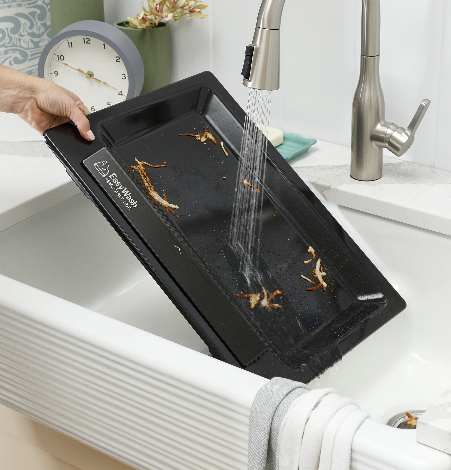 Pop Out the Enameled EasyWash Tray from the Bottom of the Oven and Rinse It Off in the Sink