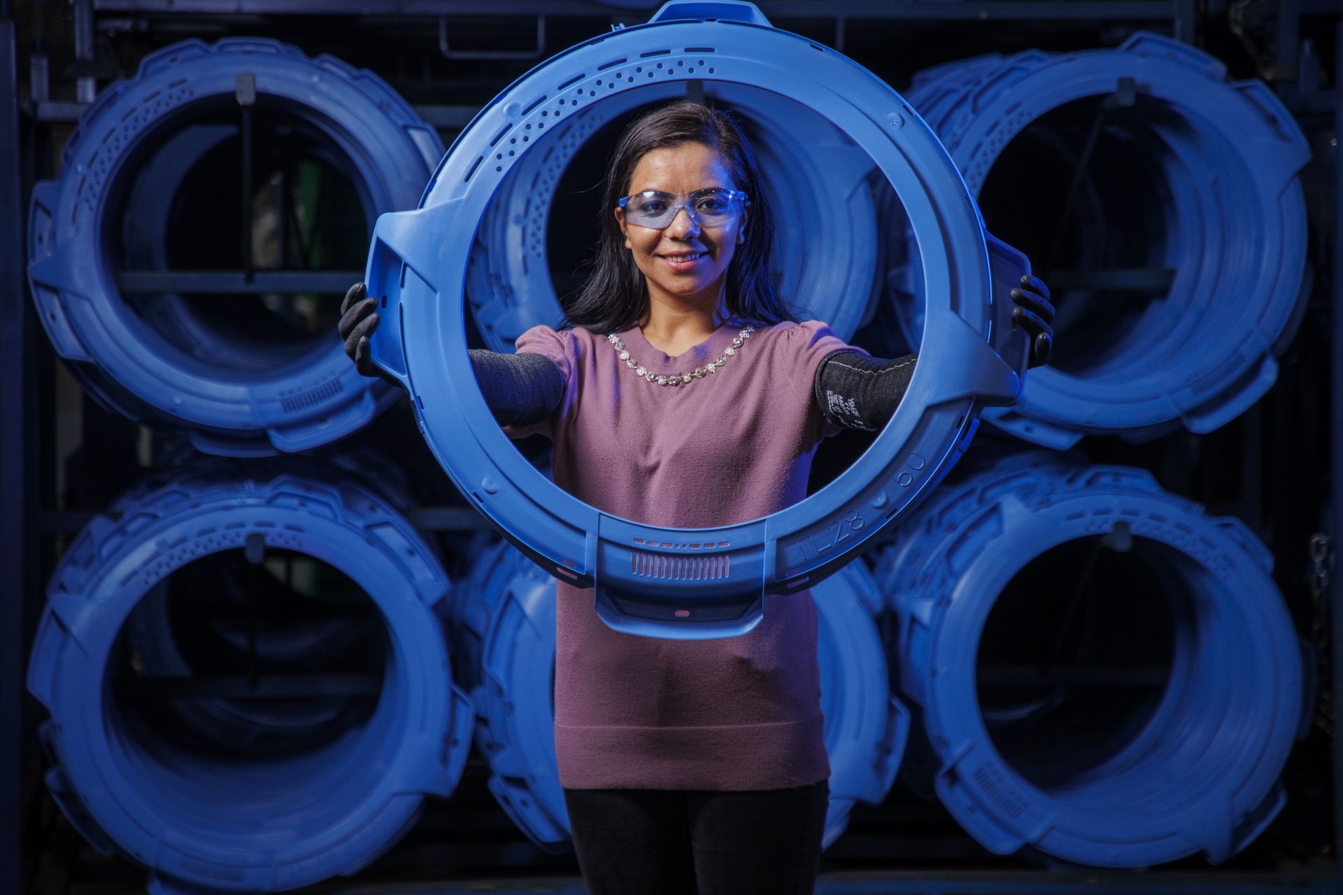 GE Appliances employee poses with parts used to build washers in the company’s laundry plant in Louisville, KY.