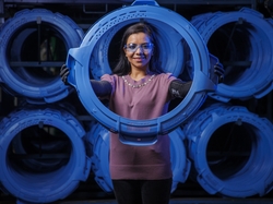 GE Appliances employee poses with parts used to build washers in the company’s laundry plant in Louisville, KY.