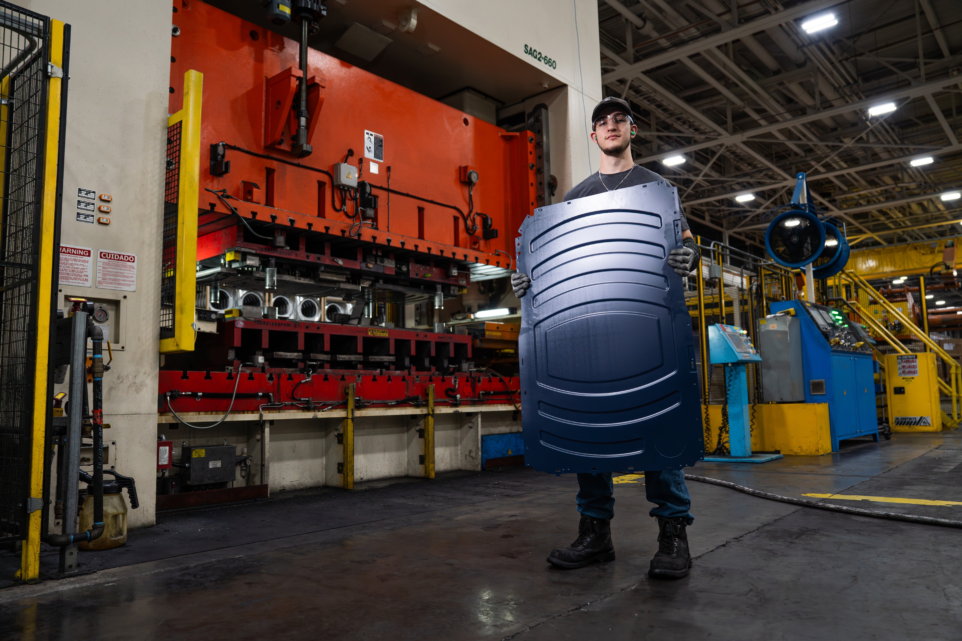 At Appliance Park in Louisville, Ky., stamping and fabrication team leader Geoffrey Bush carries a newly stamped side panel produced from galvanized steel supplied by United States Steel Corporation (U.S. Steel) in Pennsylvania and Metals USA in Ohio. This U.S.-supplier-made panel provides essential structure for front-load dryers and future washers to be built at Appliance Park as part of GE Appliances’ latest American investments.