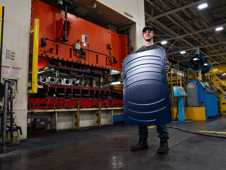 At Appliance Park in Louisville, Ky., stamping and fabrication team leader Geoffrey Bush carries a newly stamped side panel produced from galvanized steel supplied by United States Steel Corporation (U.S. Steel) in Pennsylvania and Metals USA in Ohio. This U.S.-supplier-made panel provides essential structure for front-load dryers and future washers to be built at Appliance Park as part of GE Appliances’ latest American investments. At Appliance Park in Louisville, Ky., stamping and fabrication team leader Geoffrey Bush carries a newly stamped side panel produced from galvanized steel supplied by United States Steel Corporation (U.S. Steel) in Pennsylvania and Metals USA in Ohio. This U.S.-supplier-made panel provides essential structure for front-load dryers and future washers to be built at Appliance Park as part of GE Appliances’ latest American investments.