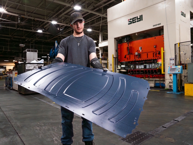 GE Appliances stamping and fabrication team leader Geoffrey Bush holds a galvanized steel side panel made using American steel from United States Steel Corporation (U.S. Steel) and Metals USA. U.S. Steel, based in Pennsylvania, and Metals USA, based in Ohio, supply the American-made steel that forms the structural body of GE Appliances’ front-load dryers and will support the new washer line being built at Appliance Park in Louisville, Ky.
