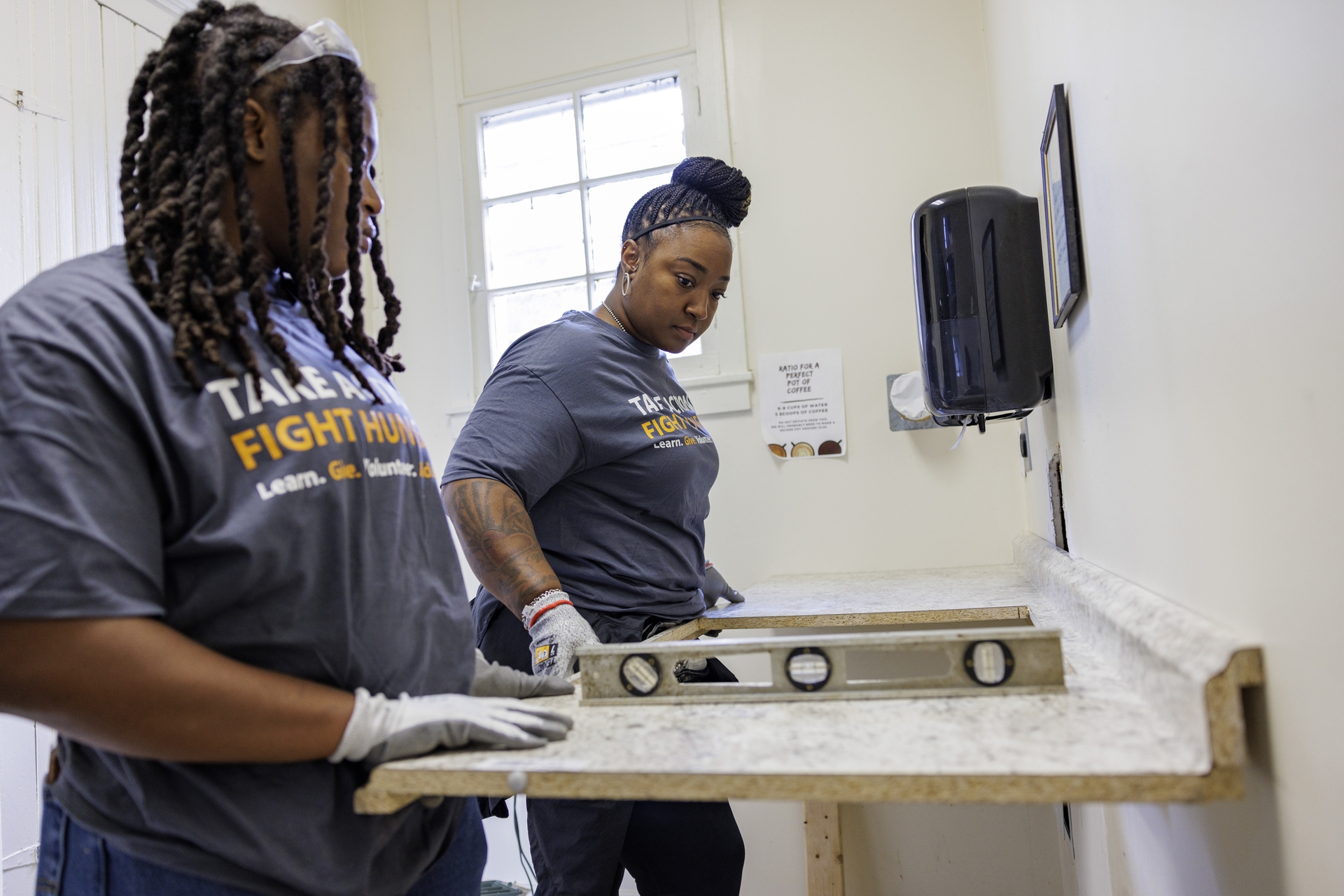 GE Appliances employees measuring and leveling countertops during Hunger Action Month.