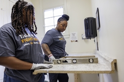 GE Appliances employees measuring and leveling countertops during Hunger Action Month.