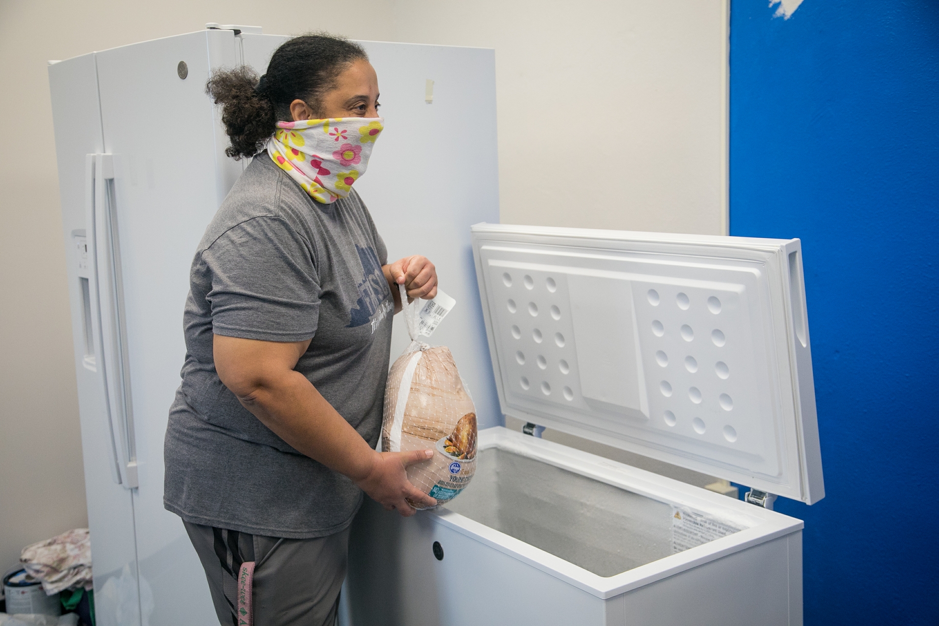 GE Appliances employees placing donated frozen food into a community freezer to support local families.