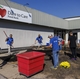 GE Appliances employees volunteering at Dare to Care Food Bank by landscaping and improving the outdoor space.