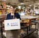 Production team member holds a Built for America sign iin the Selmer TN plant. 