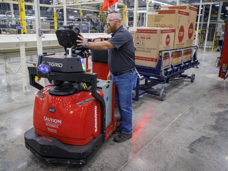 One new job created is the robot wrangler held by Scott Samples.