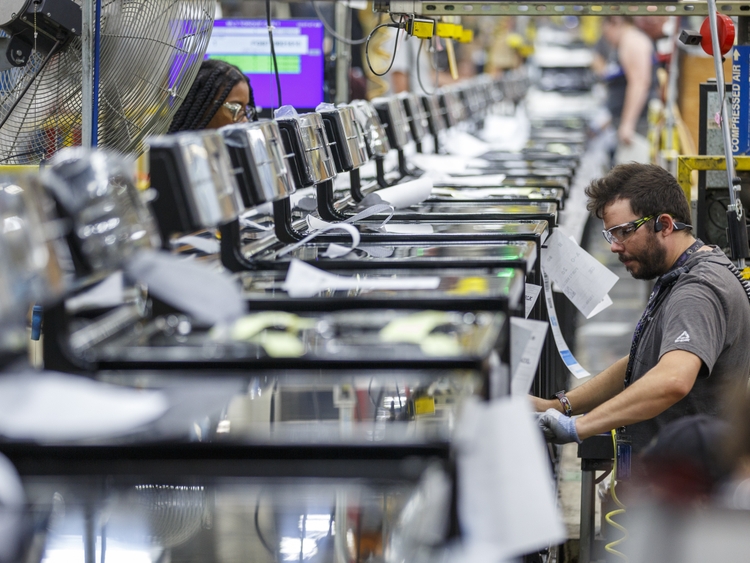 Roper employee Micheal Smith works on a manufacturing line at plant in LaFayette GA