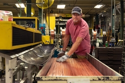 A production associate prepares materials on the line helping to build GE Appliances top freezer refrigerators in Deca