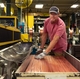 A production associate prepares materials on the line helping to build GE Appliances top freezer refrigerators in Deca