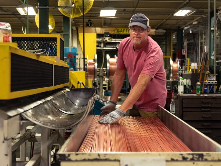 A production associate prepares materials on the line helping to build GE Appliances top freezer refrigerators in Deca A production associate prepares materials on the line helping to build GE Appliances top freezer refrigerators in Deca