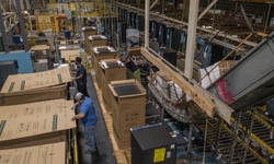 Employees box up completed refrigerator units at the Decatur Refrigeration Plant in Decatur Alabama