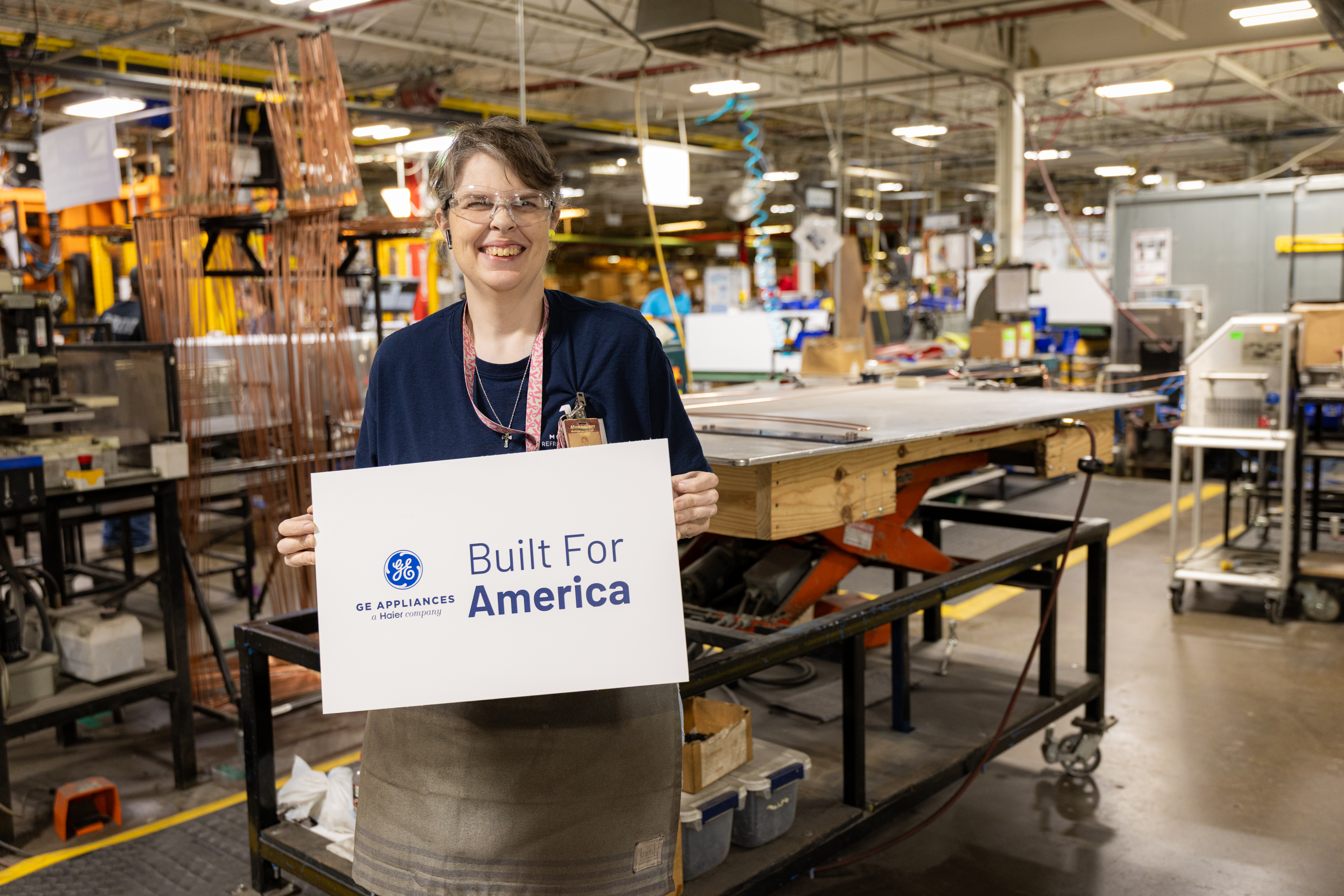 Production team member holds a Built for America sign iin the Selmer TN plant. 
