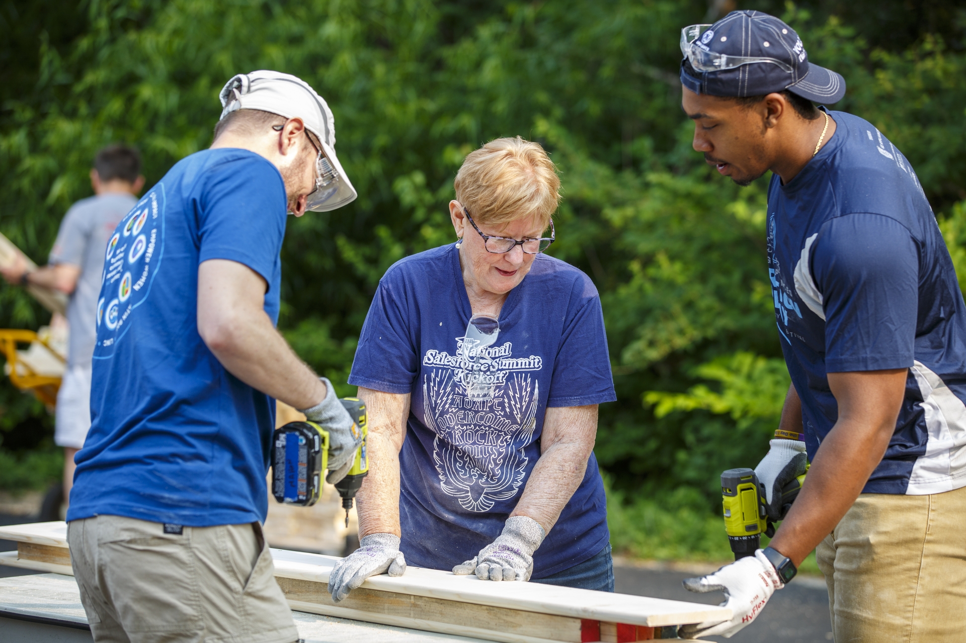 GE Appliances employees cut and assemble wood to build beds for local children who do not have beds of their own.