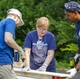 GE Appliances employees cut and assemble wood to build beds for local children who do not have beds of their own.