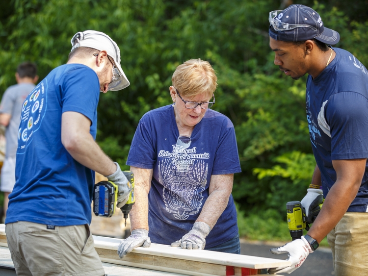 GE Appliances employees cut and assemble wood to build beds for local children who do not have beds of their own.