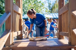 GE Appliances employees refresh a neighborhood playground improving access to safe and welcoming spaces as part of Blue Wave