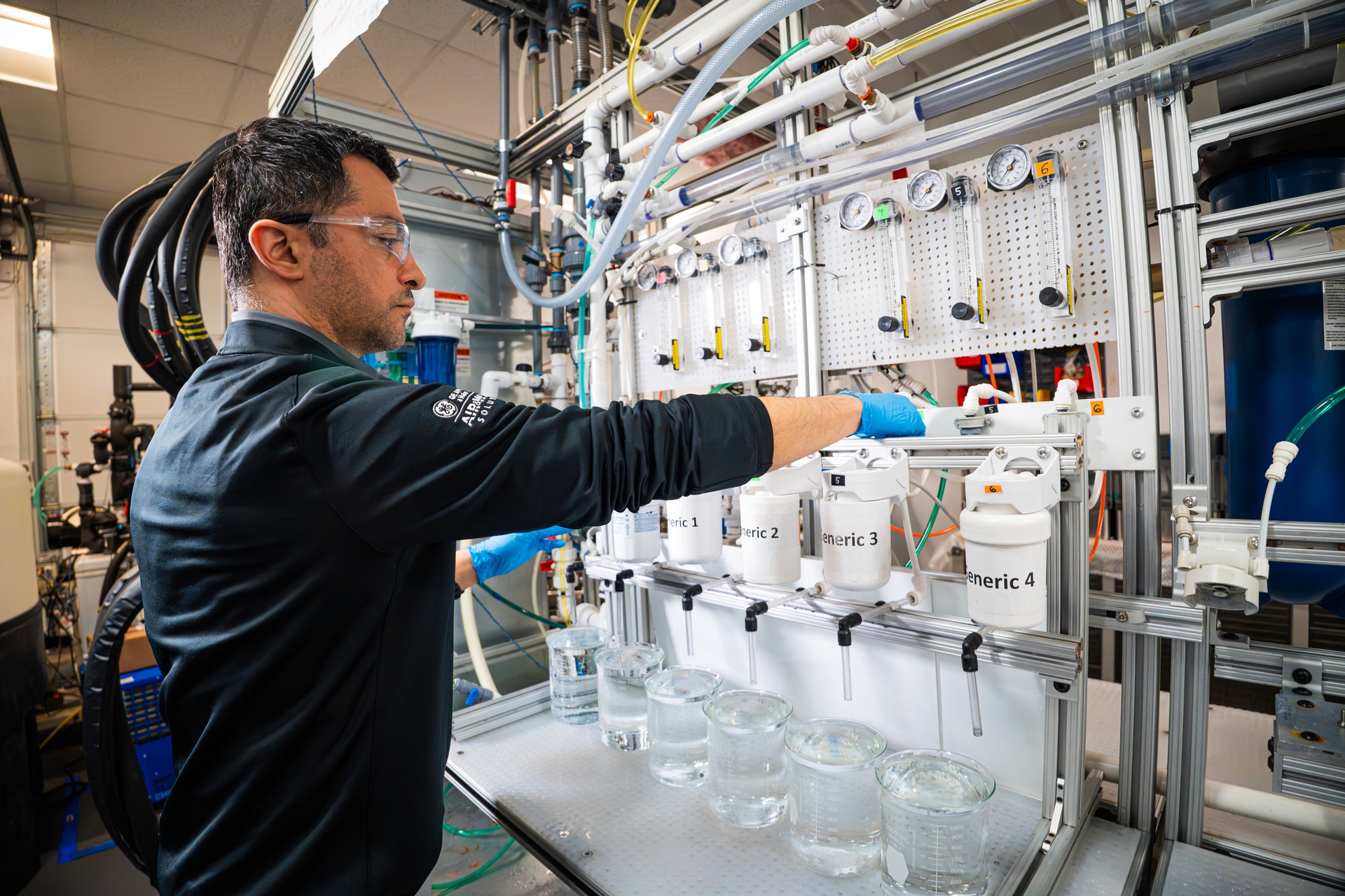 A GE Appliances scientist prepares to test counterfeit water filters against our genuine GE water filters inside the development lab at Applia
