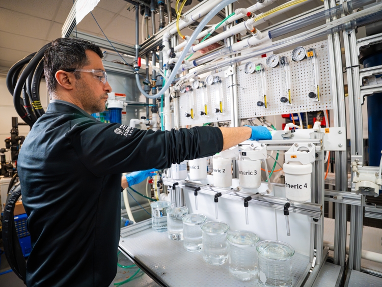 A GE Appliances scientist prepares to test counterfeit water filters against our genuine GE water filters inside the development lab at Applia
