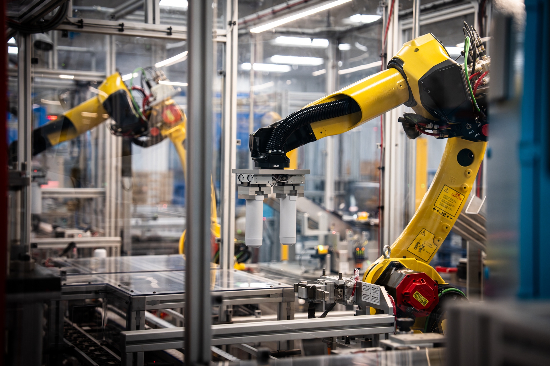 Multiple robotic arms synchronize on the water filter line at Appliance Park in Louisville KY.The new manufacturing operation is GE Applian
