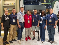 Representatives from GE Appliances and Building Homes for Heroes gather at the GE Appliances booth during the Kitchen _ Bath Industry Show KBIS