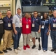 Representatives from GE Appliances and Building Homes for Heroes gather at the GE Appliances booth during the Kitchen _ Bath Industry Show KBIS