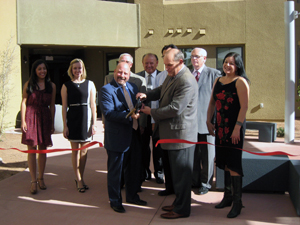 Bill Bayless, president and CEO of American Campus Communities and Robert Frank, president of UNM cut the ribbon for the Grand Opening of Casas del Rio residence halls.