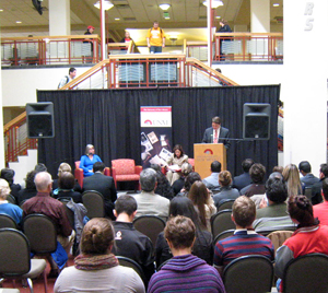 UNM Student Regent Jake Wellman introduces U.S. Secretary of Labor Hilda Solis at a brief appearance in UNM's Student Union Building.