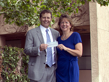 The family of Micheal W. Hansen presents check to the UNM Cen­ter for Sur­gi­cal Crit­i­cal Care.