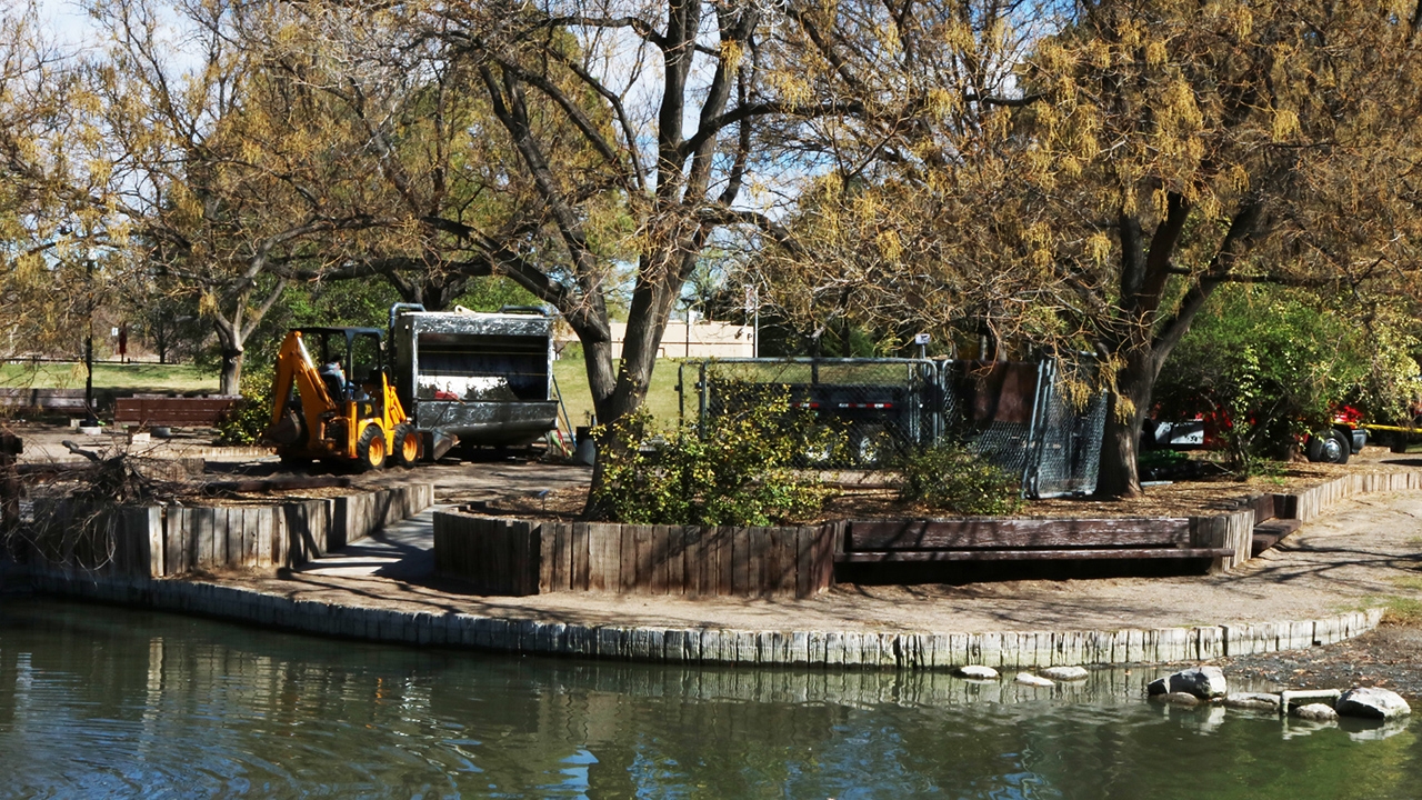 Workers move cleaning equipment