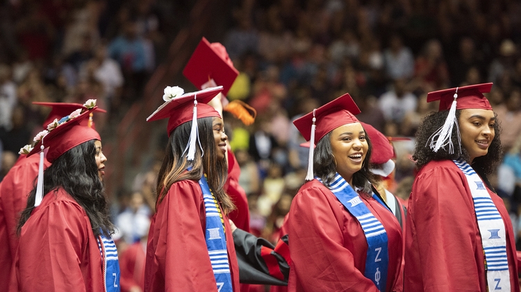 Graduates wait in line to cross the dais 