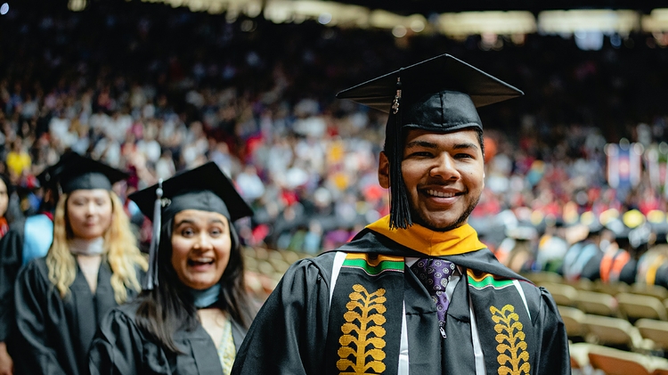 Grad smiles upon arena entry.